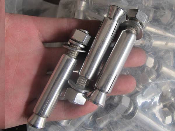 Two stainless steel wire rope snap hook in a hand.